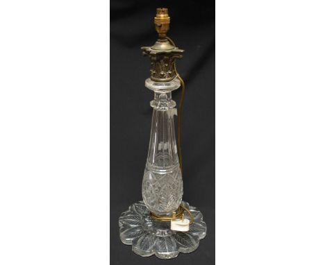 A large cut glass table lamp of baluster form with brass composite capital on shaped base cut to underside with leaves, 50cm 