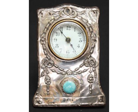 An Edwardian silver mounted easel clock, hallmarked Birmingham 1908, embossed with ribbons and harebells, set with circular m
