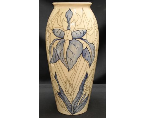 An unfinished Moorcroft pottery trial lamp base of tall ovoid form, decorated with a blue flower and leaves on a cream ground