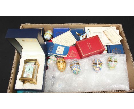 A collection of assorted boxed and unboxed Halcyon Days and other enamel boxes, together with display stands, and two books o