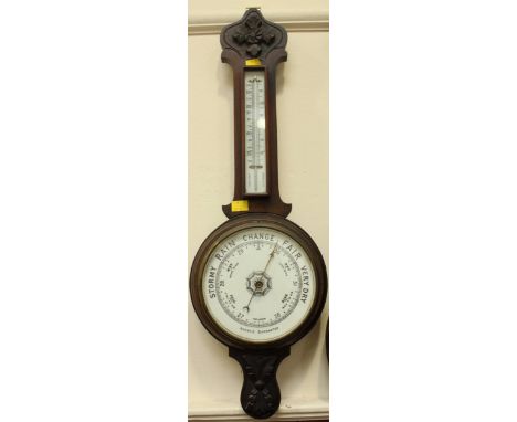 An Edwardian carved mahogany aneroid banjo barometer, with thermometer. 80 cm high. -60