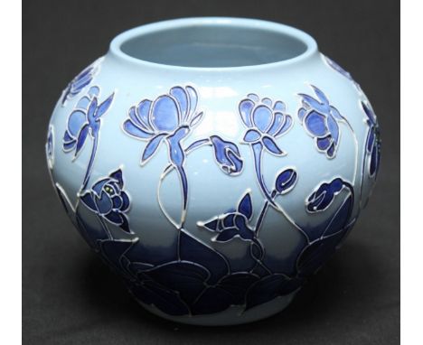 A Moorcroft pottery vase of globular form, decorated with blue plants and leaves to a light blue ground. The base signed over