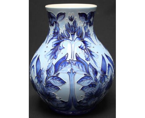 A Moorcroft pottery vase of globular form with flared rim, decorated with blue plants and leaves to a light blue ground. Sign