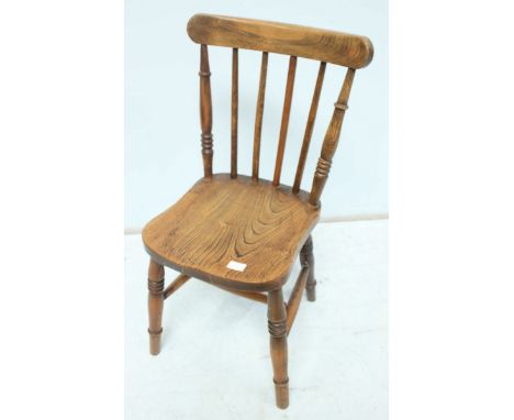 A child's Victorian stick back elm single chair, with solid seat and supported on turned legs.