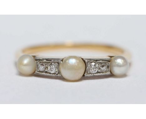 A gold, pearl and diamond ring, set with three seed pearls, each interspersed by two small diamonds.