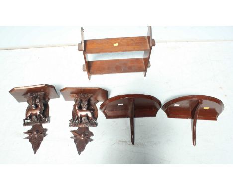 A pair of early 20th century carved Blackforest wall brackets, carved with deer, together with a small wall shelf and a small