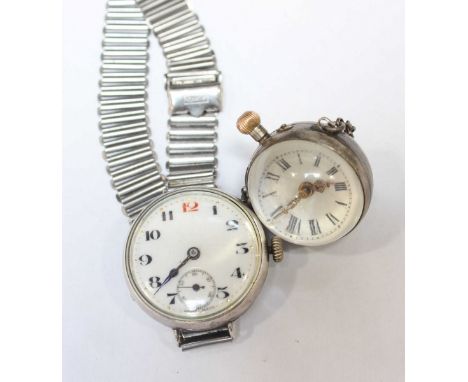 An early 20th century silver cased wrist watch, together with a modern ball clock. (2)