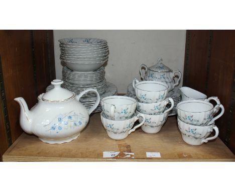 SECTION 29. A Myott white glazed porcelain dinner service and tea set, decorated with blue flowers.