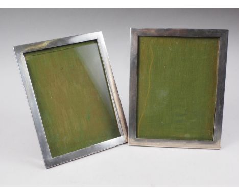 A pair of engine turned silver photograph frames, 9 1/4" overall (one easel damaged)