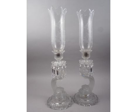 A pair of Baccarat glass candlesticks with frosted dolphin stems, cut glass drops and engraved glass storm shades, 23" high o