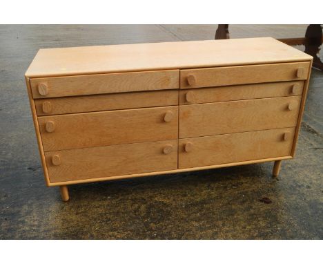 A light oak chest of four short and four deep drawers, on turned splay supports, 52" wide x 18" deep x 28" high 