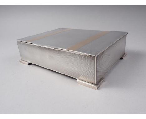 An Elkington &amp; Co engine turned and yellow metal banded silver cigarette box 