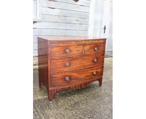 A Georgian mahogany bowfront chest of two short and two long drawers with ring handles, on bracket supports, 40" wide x 21" d