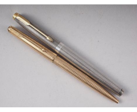 A Parker engine turned silver fountain pen with gold nib, and a similar rolled gold ballpoint pen 