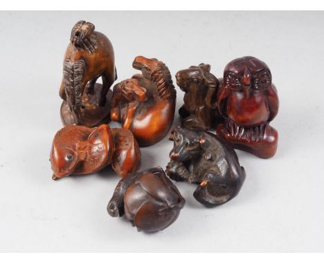 Two carved hardwood horse netsuke, a dog, a ram, two birds and a pair of carp 