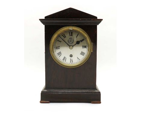 An RAF officers mess mantle clock,  WWII, the oak case with silvered dial, Roman numerals and Royal Air Force insignia, the e