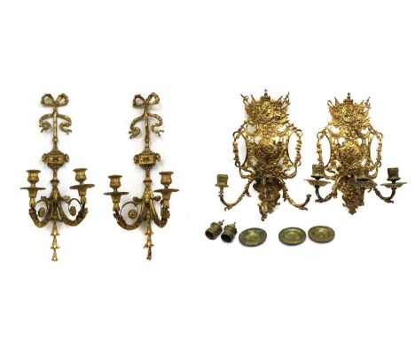 A pair of neoclassical gilt gesso wall sconces19th century, with ribbon bow crestings, acanthus leaf and ram's head decoratio