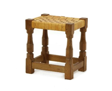 A Robert 'Mouseman' Thompson oak stool,with a tan leather latticed seat, raised on turned octagonal supports, one carved with