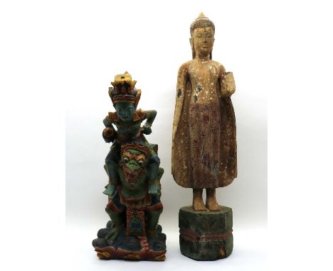 A Thai papier-mâché Buddha, 20th century, wearing a long robe standing on a wooden pedestal, his hands in Abhaya mudra,89cm h