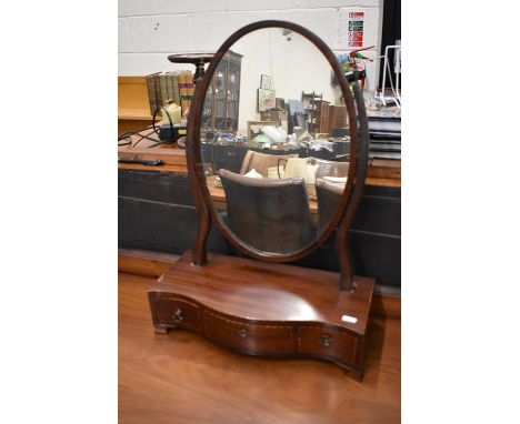 A 19th century mahogany oval toilet mirror on three drawer serpentine platform base on bracket feet, 42 cm wide x 60 cm highP