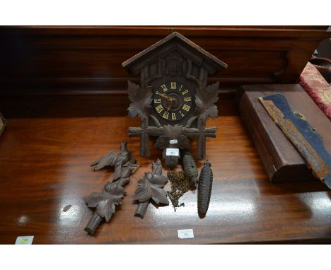 An antique stained pine Swiss cuckoo clock with cast iron fir cone weights, a/f, 39 cm highPlease note that all lots are seco
