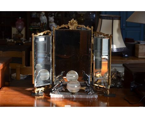 An Art Deco table lamp with cast metal berry-eating birds and globular glass shade on marble base to/w profusely carved oak t