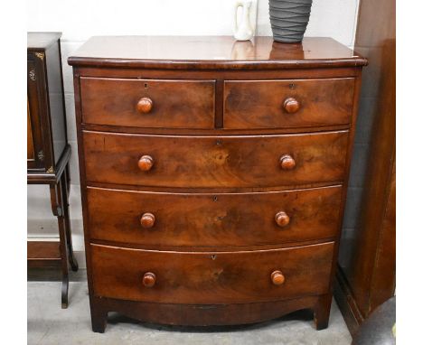 A large Victorian mahogany bowfront chest of two short over three long drawers with turned handles raised on shaped bracket f