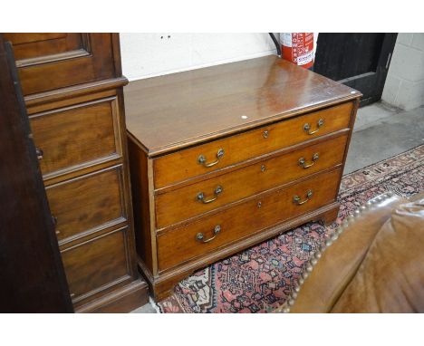 A 19th century oak chest of three long drawers, raised on shaped bracket feet, 100 cm wide