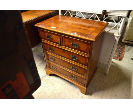 A small reproduction yew wood crossbanded chest of two short over three long drawers raised on bracket feet, 61 cm wide x 40 