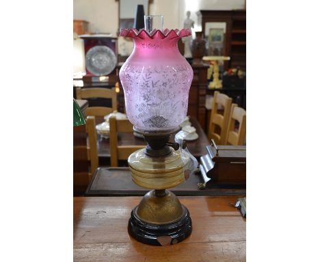 Victorian brass and glass oil lamp with seccessionist style cranberry etched glass shade, 54 cm overall including chimney