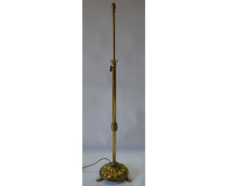 An antique brass standard lamp on a relief pressed circular base, converted from a telescopic oil lamp, wired for UK use, app