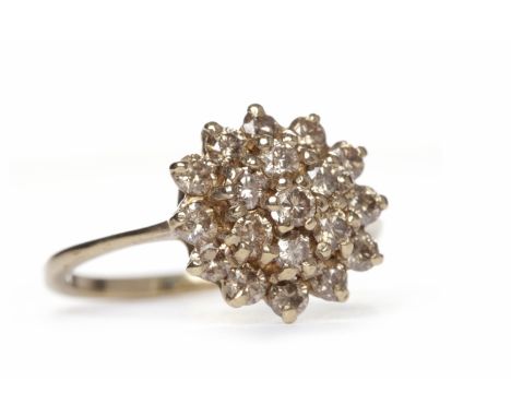 COLOURED DIAMOND CLUSTER RINGthe round bezel with round cognac coloured diamonds, in nine carat gold, size P, 2.5g