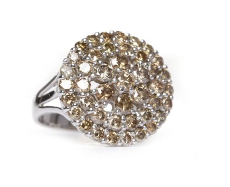 COGNAC COLOURED DIAMOND CLUSTER RINGwith graduated round brilliant cut diamonds, totalling very approximately 1.28 carats, in