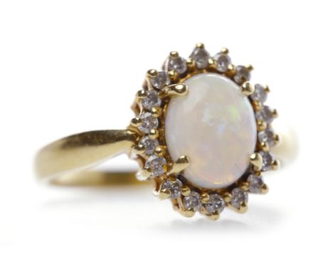 OPAL AND DIAMOND RINGthe oval shaped opal with dimensions of 2.5x1.2mm, surrounded by a halo of diamonds totalling approximat