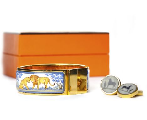 HERMES ENAMELLED BANGLEdecorated with two sections of enamel depicting a male and female lion, marked HERMES B and with an in