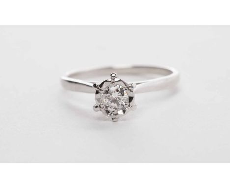 DIAMOND SOLITAIRE RINGthe illusion set round brilliant cut diamond of approximately 0.23 carats, in eighteen carat white gold