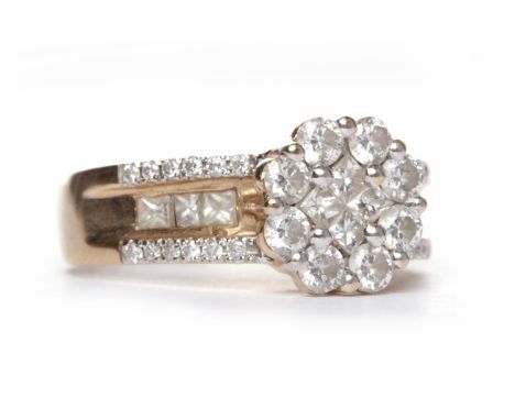 EIGHTEEN CARAT ROSE GOLD DIAMOND RINGthe round bezel with four princess cut diamonds to the centre surrounded by round brilli