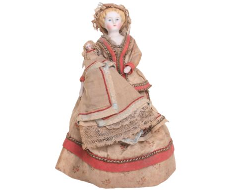 Early miniature Parian-type shoulder head doll and baby, with painted features, moulded blonde hair and on a cloth body with 