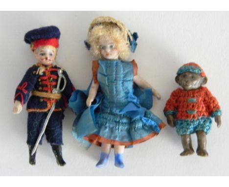 Pair of miniature all-bisque dolls and a monkey, the dolls with painted features, girl having swivel head both jointed at sho