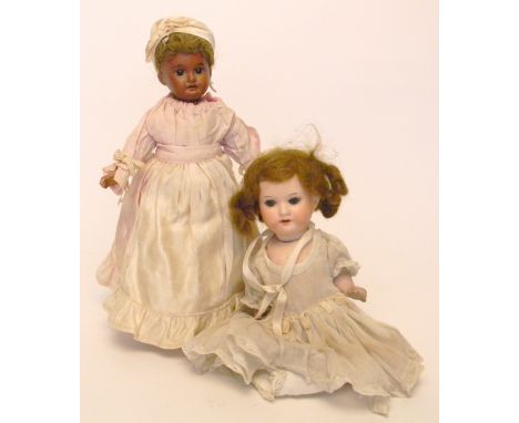 A.M 1894 mulatto bisque head doll, German circa 1910, with fixed brown glass eyes, open mouth and brown wig, on a fully joint