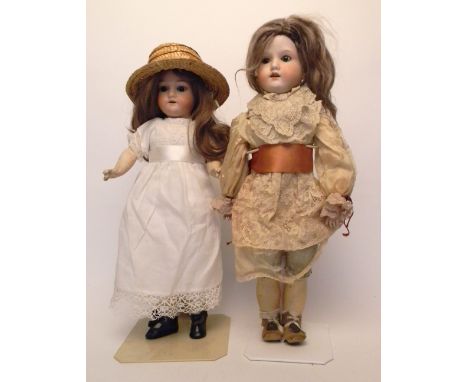 A.M 390 bisque head doll, German circa 1910, with weighted brown glass eyes, open mouth, upper teeth and brown wig, on a full