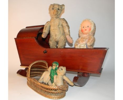 Steiff Teddy bear, circa 1909, soft toys and cradle, the straw filled blonde mohair bear with black boot button eyes, tan sti