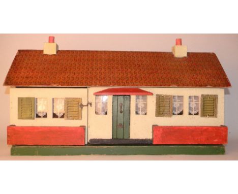 Painted wooden cottage, circa 1930, with cream exterior, six windows with four card printed shutters, green front door with k