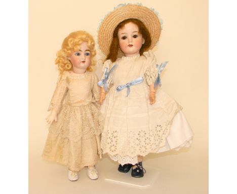 : A.M 390 bisque head doll, German circa 1910, With weighted brown glass eyes, lashes, open mouth, upper teeth and brown wig,