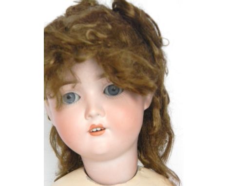 : ‘The Dollar Princess, Special’ bisque head doll, with weighted blue glass eyes, open mouth, upper teeth and auburn hair, on