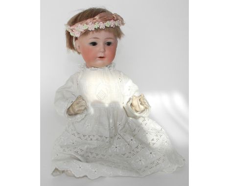 Heubach 10532 bisque head baby, German circa 1910, with weighted brown glass eyes, lashes, open mouth and upper teeth, on a c