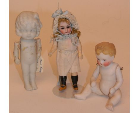 Miniature bisque head doll, German circa 1910, with  glass eyes, closed mouth, and blonde curly hair, on a composition body a