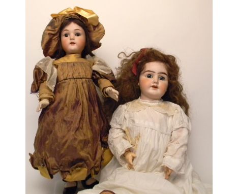 Simon & Halbig bisque head doll, German circa 1910, with weighted brown glass eyes, open mouth, upper teeth and brown wig, on