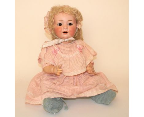 A.M 327 bisque head baby, German circa 1910, With weighted brown glass eyes, open mouth and blonde wig, on a composition baby