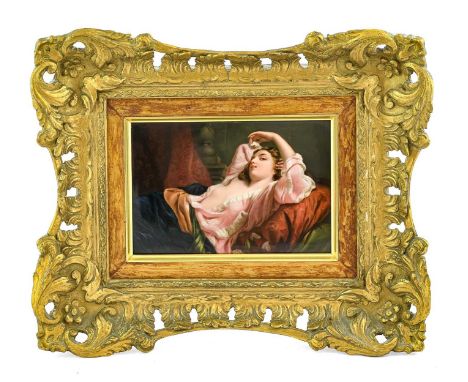 A KPM Berlin Porcelain Plaque, mid 19th century, of rectangular form, painted with a girl reclining languorously on a sofa, 1